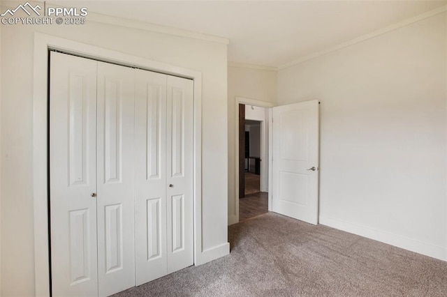527 Golden Grain Ln, Divide, CO 80814 - unfurnished bedroom with carpet, a closet, ornamental molding, and baseboards