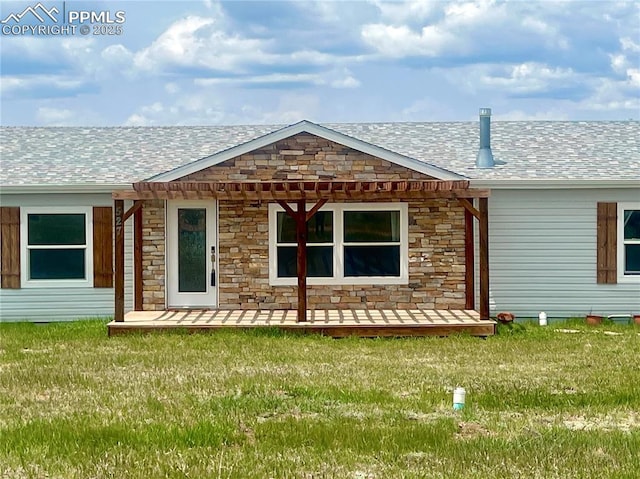 527 Golden Grain Ln, Divide, CO 80814 - back of property with stone siding, a lawn, and a shingled roof