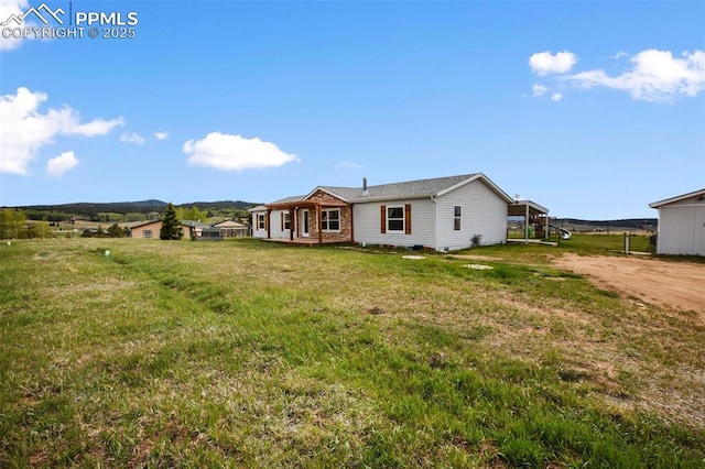 527 Golden Grain Ln, Divide, CO 80814 - rear view of house with a lawn