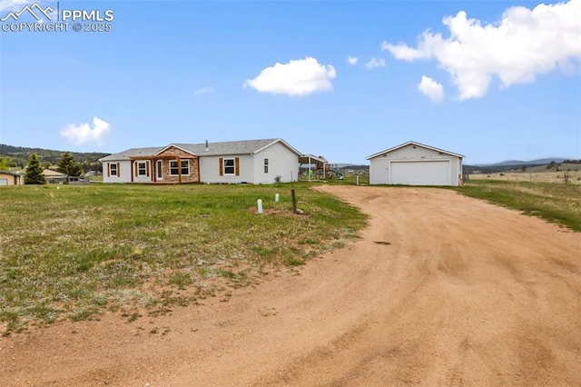 527 Golden Grain Ln, Divide, CO 80814 - ranch-style house featuring driveway, an outbuilding, a detached garage, and a front lawn