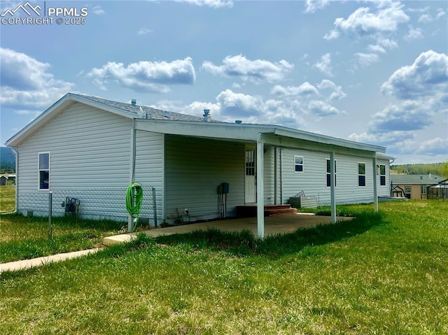 527 Golden Grain Ln, Divide, CO 80814 - rear view of house with a yard, a patio area, and a carport