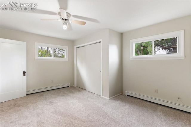 15 W Brookside St, Colorado Springs, CO 80905 - unfurnished bedroom featuring a baseboard heating unit, multiple windows, and carpet