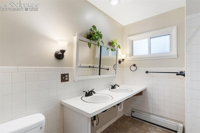 15 W Brookside St, Colorado Springs, CO 80905 - bathroom featuring baseboard heating, tile walls, a sink, toilet, and wainscoting