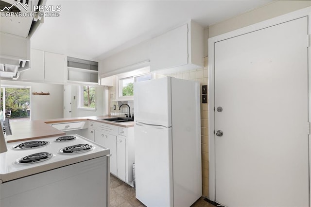 15 W Brookside St, Colorado Springs, CO 80905 - kitchen with white appliances, a sink, white cabinets, and plenty of natural light
