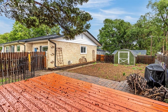 1604 E Kiowa St, Colorado Springs, CO 80909 - wooden deck featuring a storage unit and a fenced backyard