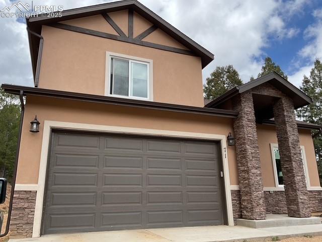 71 Mt Elbert Dr, Florissant, CO 80816 - view of front of house featuring stucco siding, stone siding, and driveway