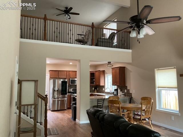 71 Mt Elbert Dr, Florissant, CO 80816 - living area with ceiling fan, high vaulted ceiling, wood finished floors, and baseboards
