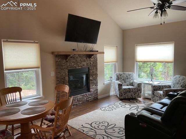 71 Mt Elbert Dr, Florissant, CO 80816 - living room with high vaulted ceiling, ceiling fan, wood finished floors, and a stone fireplace