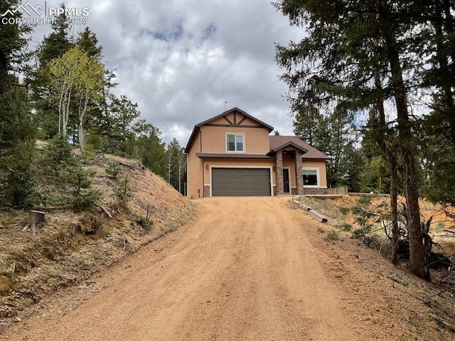 71 Mt Elbert Dr, Florissant, CO 80816 - view of front of property featuring driveway, stucco siding, and an attached garage