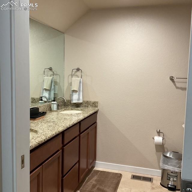 71 Mt Elbert Dr, Florissant, CO 80816 - bathroom with double vanity, baseboards, and lofted ceiling