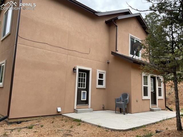 71 Mt Elbert Dr, Florissant, CO 80816 - back of house featuring stucco siding and a patio