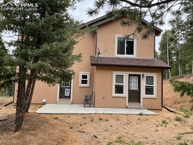 71 Mt Elbert Dr, Florissant, CO 80816 - back of house with stucco siding and a patio