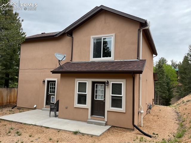 71 Mt Elbert Dr, Florissant, CO 80816 - rear view of property with stucco siding and a patio area