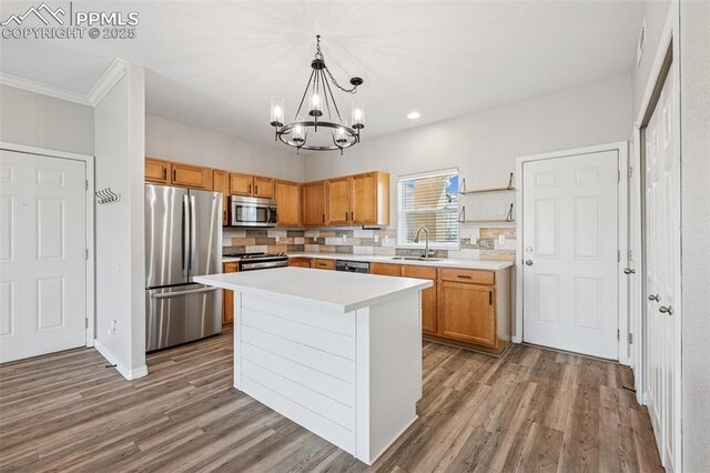 4807 Kerry Lynn Vw Unit 102, Colorado Springs, CO 80922 - kitchen featuring appliances with stainless steel finishes, a sink, a chandelier, ornamental molding, and light countertops
