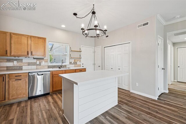 4807 Kerry Lynn Vw Unit 102, Colorado Springs, CO 80922 - kitchen with stainless steel dishwasher, a sink, dark wood finished floors, a chandelier, and crown molding