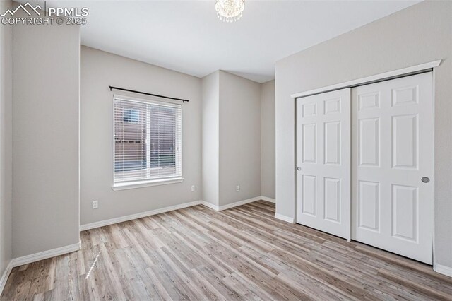 4807 Kerry Lynn Vw Unit 102, Colorado Springs, CO 80922 - unfurnished bedroom with wood finished floors, baseboards, and a closet