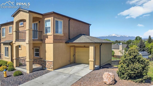 4807 Kerry Lynn Vw Unit 102, Colorado Springs, CO 80922 - view of front facade featuring stucco siding, driveway, a mountain view, and an attached garage