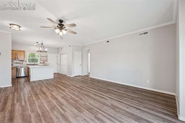 4807 Kerry Lynn Vw Unit 102, Colorado Springs, CO 80922 - unfurnished living room featuring ceiling fan, baseboards, ornamental molding, wood finished floors, and a chandelier