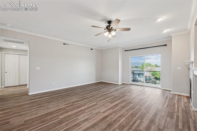 4807 Kerry Lynn Vw Unit 102, Colorado Springs, CO 80922 - unfurnished living room featuring wood finished floors, baseboards, ceiling fan, crown molding, and a fireplace