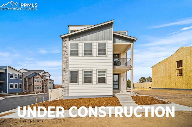 3071 Curly Grv, Colorado Springs, CO 80922 - view of front facade featuring a balcony and stone siding