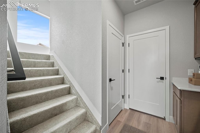 3071 Curly Grv, Colorado Springs, CO 80922 - stairway featuring wood finished floors and a textured wall