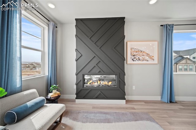3071 Curly Grv, Colorado Springs, CO 80922 - sitting room featuring a fireplace, light wood finished floors, baseboards, and recessed lighting