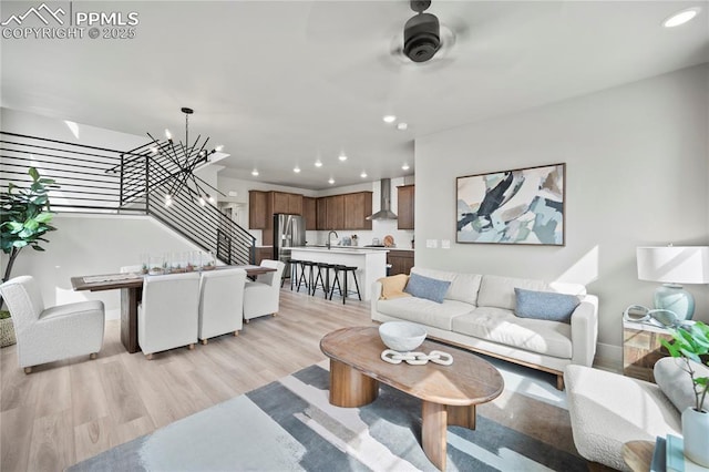 3071 Curly Grv, Colorado Springs, CO 80922 - living room with light wood-style floors, stairs, recessed lighting, a chandelier, and baseboards