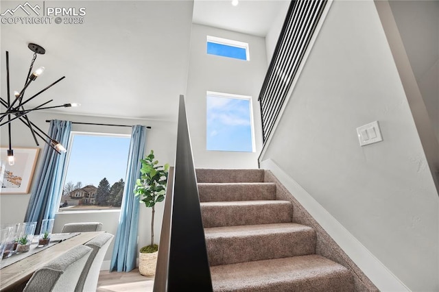 3071 Curly Grv, Colorado Springs, CO 80922 - stairs with a chandelier and a towering ceiling