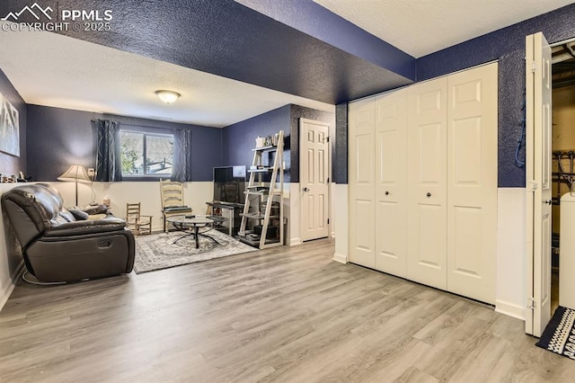 3566 Verde Dr, Colorado Springs, CO 80910 - living room with wood finished floors, a textured ceiling, a textured wall, and baseboards