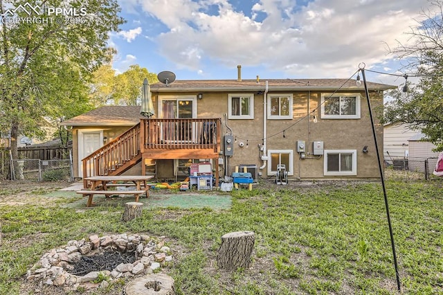 3566 Verde Dr, Colorado Springs, CO 80910 - back of property with stairs, a wooden deck, stucco siding, and an outdoor fire pit