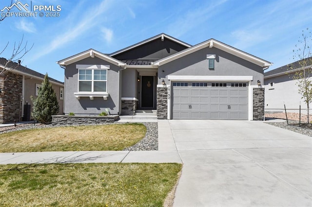 10192 Kentwood Dr, Colorado Springs, CO 80924 - view of front of house with stone siding, stucco siding, a garage, driveway, and a standing seam roof