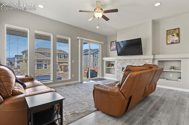 10192 Kentwood Dr, Colorado Springs, CO 80924 - living room with ceiling fan, wood finished floors, built in features, baseboards, and recessed lighting