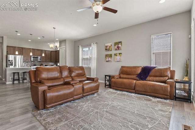 10192 Kentwood Dr, Colorado Springs, CO 80924 - living area featuring a ceiling fan, light wood-type flooring, recessed lighting, baseboards, and a chandelier