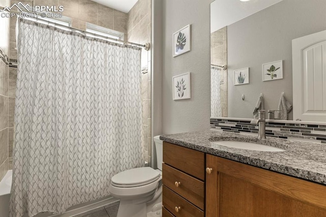 10192 Kentwood Dr, Colorado Springs, CO 80924 - full bath featuring vanity, toilet, shower / bath combination with curtain, tile patterned floors, and tasteful backsplash