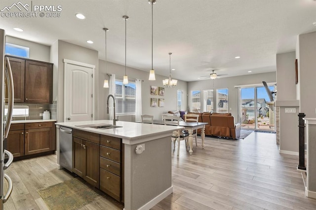 10192 Kentwood Dr, Colorado Springs, CO 80924 - kitchen featuring a sink, appliances with stainless steel finishes, ceiling fan, light wood-style flooring, and light countertops