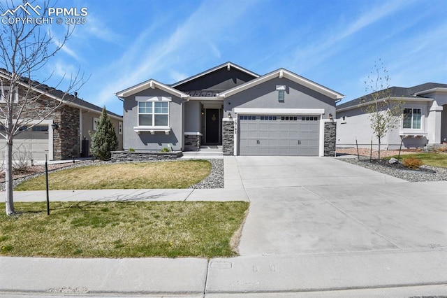 10192 Kentwood Dr, Colorado Springs, CO 80924 - view of front of home featuring stucco siding, stone siding, driveway, and an attached garage