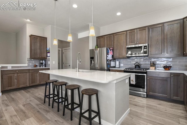 10192 Kentwood Dr, Colorado Springs, CO 80924 - kitchen with appliances with stainless steel finishes, a sink, backsplash, light countertops, and recessed lighting