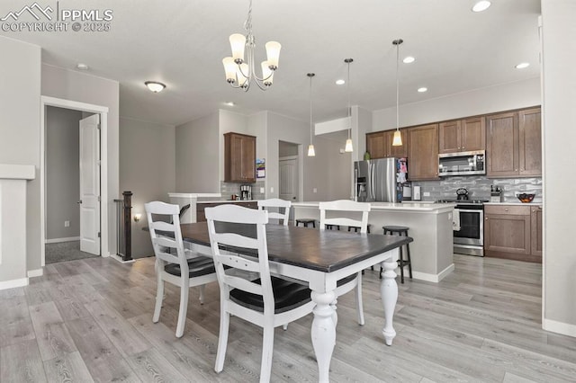10192 Kentwood Dr, Colorado Springs, CO 80924 - dining area featuring a chandelier, light wood finished floors, recessed lighting, and baseboards