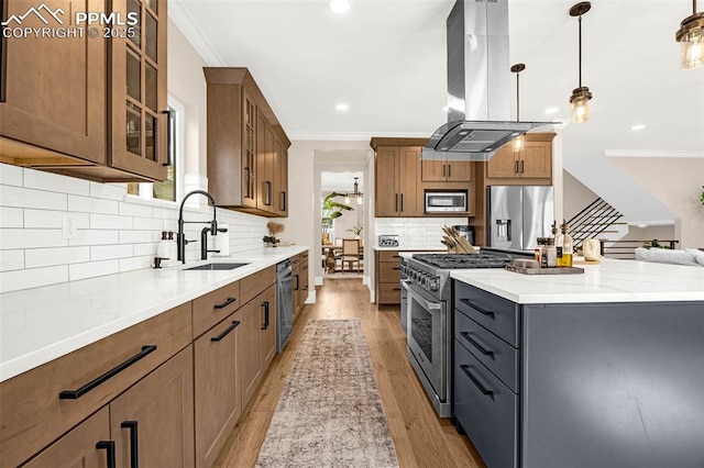 2625 Steele St, Denver, CO 80205 - kitchen featuring island range hood, a sink, appliances with stainless steel finishes, brown cabinets, and ornamental molding