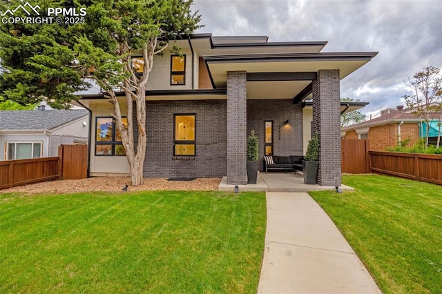 2625 Steele St, Denver, CO 80205 - view of front of house featuring brick siding, an outdoor hangout area, and a patio