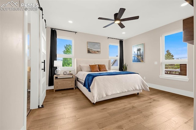 2625 Steele St, Denver, CO 80205 - bedroom featuring light wood-style flooring, multiple windows, baseboards, and recessed lighting