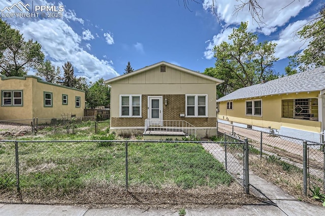 228 N Hancock Ave, Colorado Springs, CO 80903 - view of front of property with brick siding and a fenced front yard