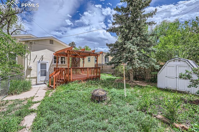 228 N Hancock Ave, Colorado Springs, CO 80903 - fenced backyard featuring a fire pit, a wooden deck, and a pergola