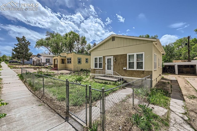 228 N Hancock Ave, Colorado Springs, CO 80903 - view of front of house with brick siding and a fenced front yard