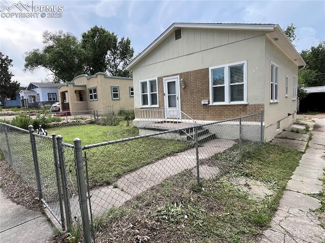 228 N Hancock Ave, Colorado Springs, CO 80903 - view of front of home featuring brick siding and a fenced front yard