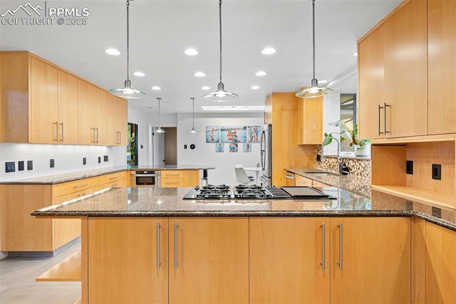 312 Lake Ave, Colorado Springs, CO 80906 - kitchen featuring a peninsula, a sink, dark stone counters, stainless steel appliances, and recessed lighting