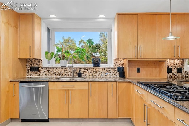 312 Lake Ave, Colorado Springs, CO 80906 - kitchen featuring stainless steel dishwasher, black gas stovetop, a sink, dark stone counters, and backsplash
