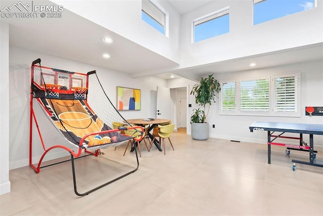 312 Lake Ave, Colorado Springs, CO 80906 - rec room with baseboards, healthy amount of natural light, a towering ceiling, and recessed lighting