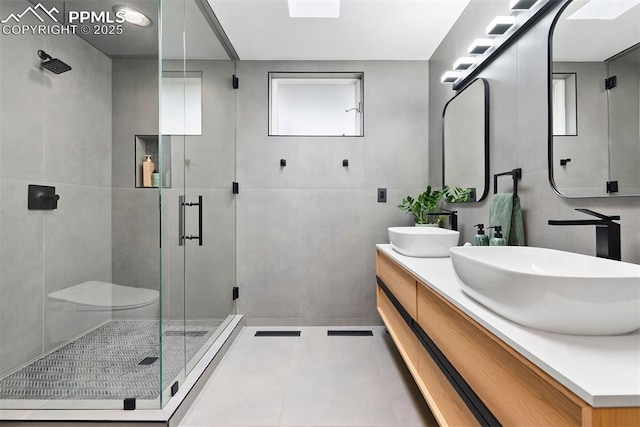 312 Lake Ave, Colorado Springs, CO 80906 - bathroom with a shower stall, double vanity, and tile patterned flooring