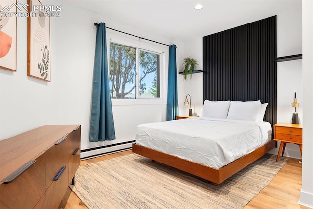 312 Lake Ave, Colorado Springs, CO 80906 - bedroom featuring a baseboard heating unit, light wood-type flooring, and recessed lighting